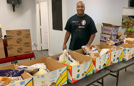 Pastor Davis with Company Donated Food Boxes