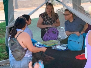 Riverside County Supervisor, Yxstian Gutierrez and assistant helping out