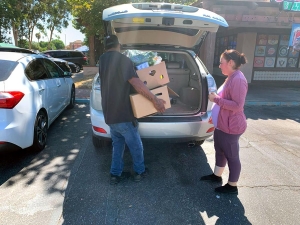 Brother Will putting full food boxes in car