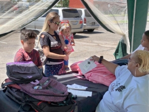 Minister Shelia Woods at backpack station